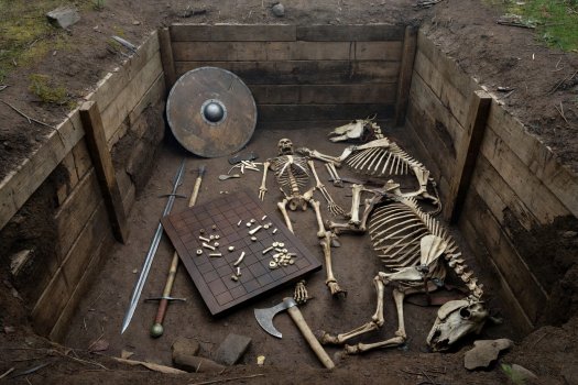 Render of the reconstructed chamber grave Bj 581 at Birka with gaming board, weapons, and sacrificed horses